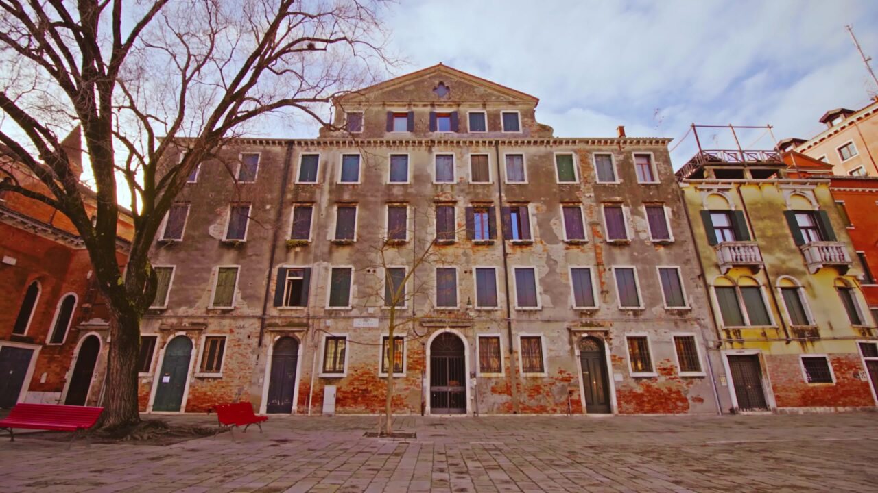 Venice city square with old shabby terracotta buildings