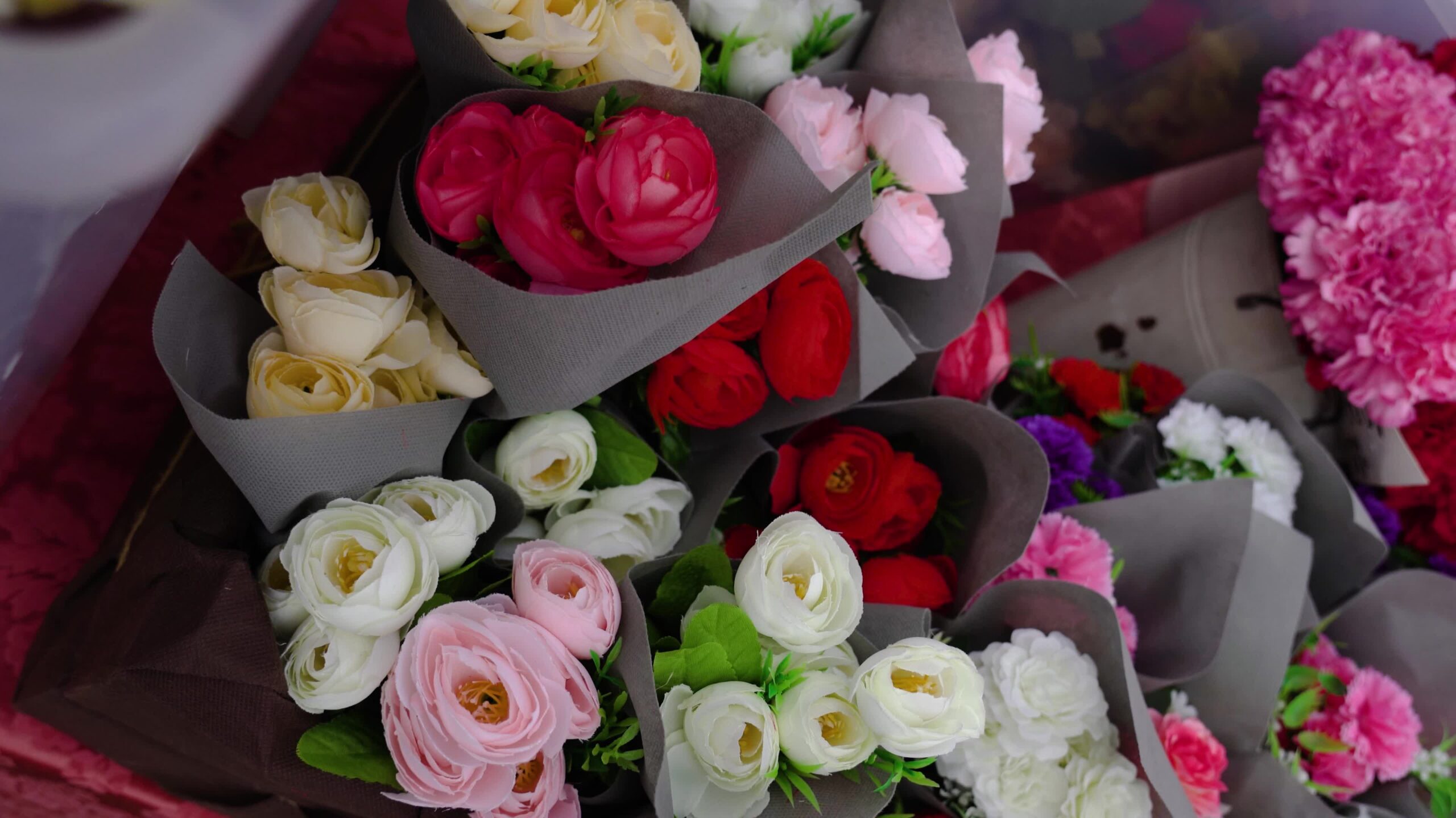 Motion over colourful roses arrangements wrapped in paper