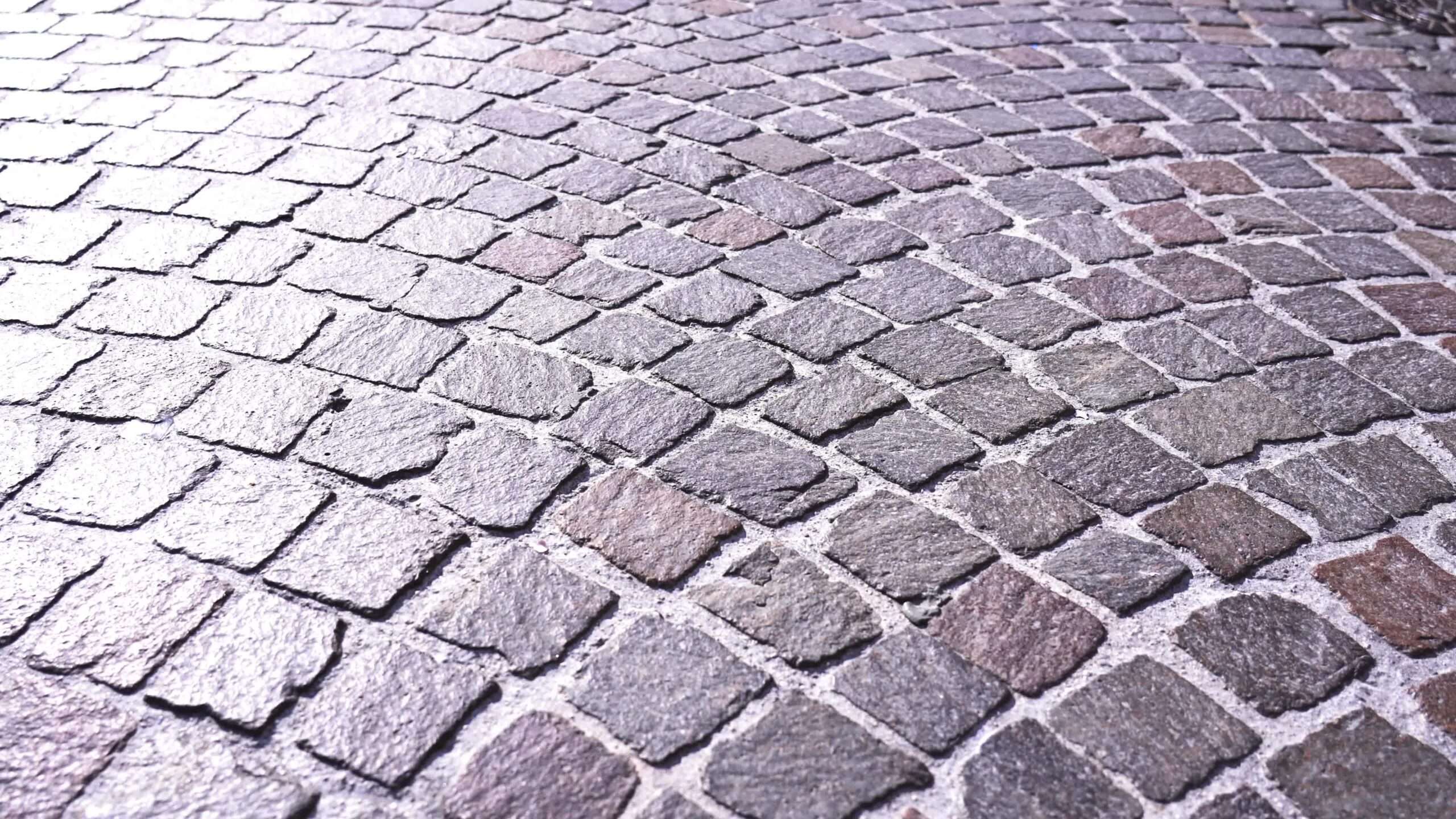 Designed grey granite pavement on local road in old town