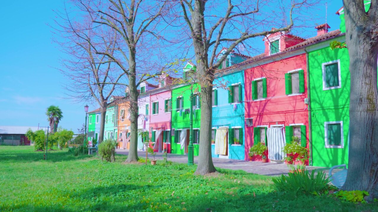 Multi-colored houses in morning under blue sky in Burano