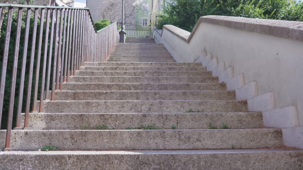 Long old stone stairway with handrails as tourist attraction