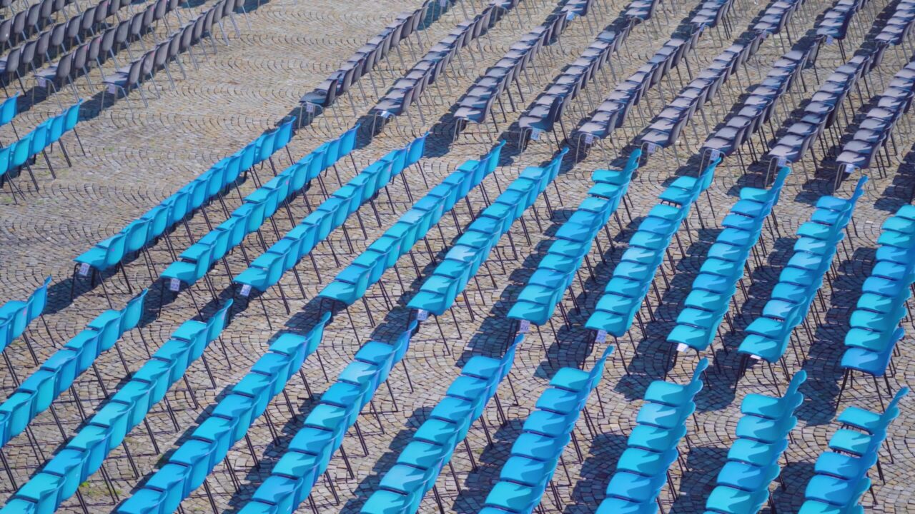 Rows of blue seat chairs for observation of local events