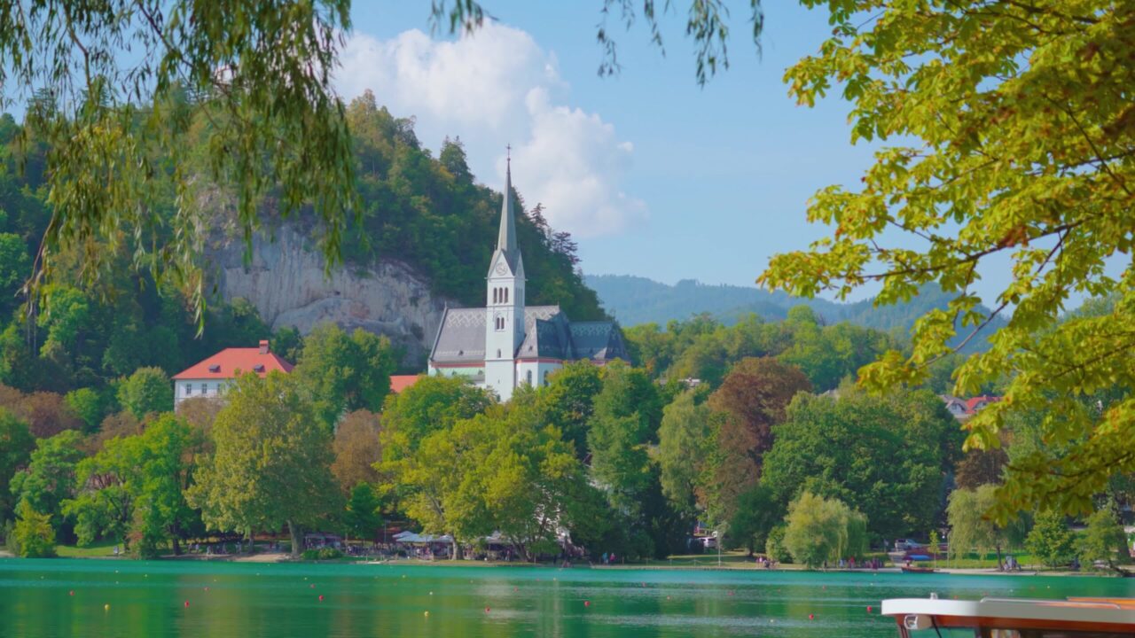 Saint Martin Parish church among lush trees near Bled lake