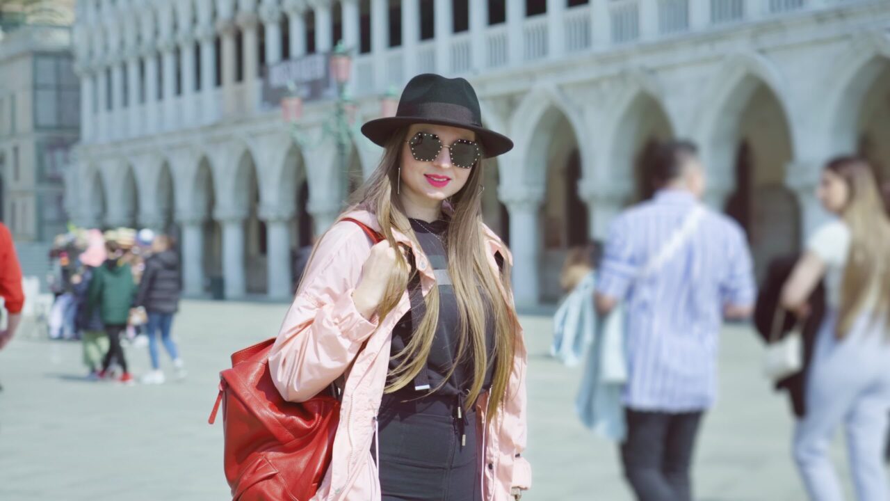 Young woman tourist stands on St. Mark Square in Venice