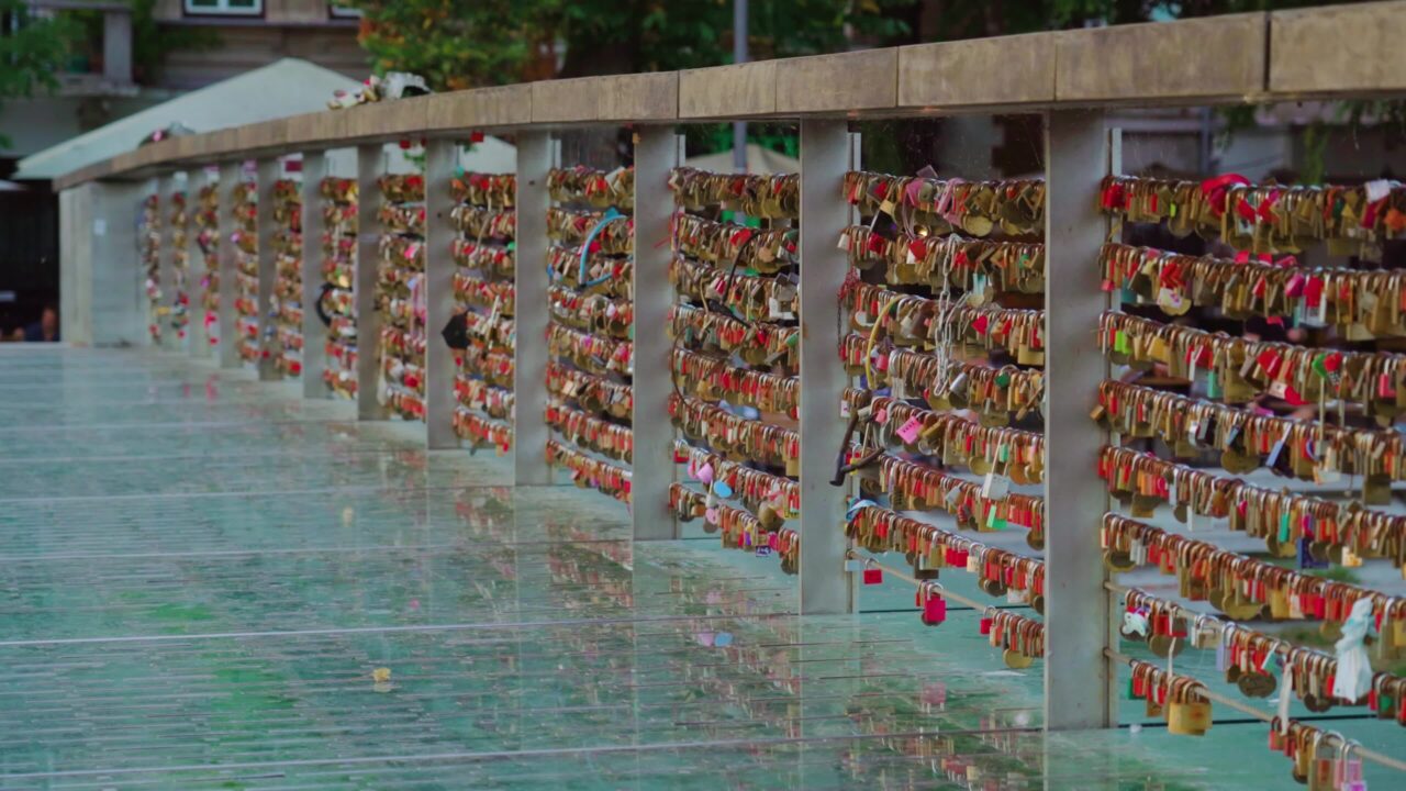 Love locks on glass bridge railing in capital of Slovenia