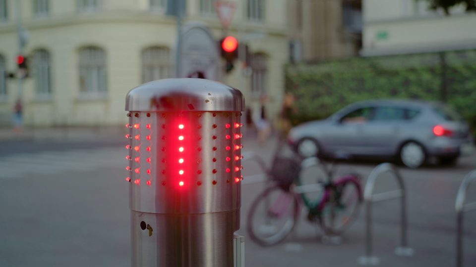 Stop sign located on street of Ljubljana flashes with red