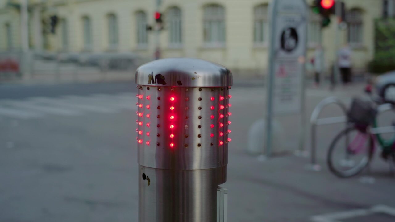 Stop signal on street barrier flashes with red colour