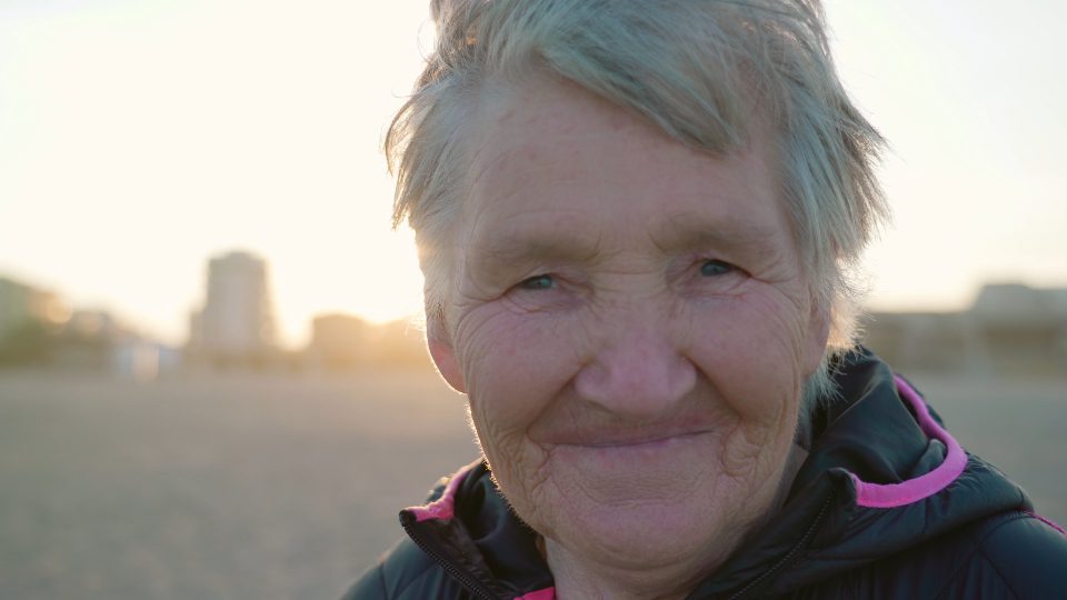 Sunset Smile – Radiant Face of an Elderly Woman