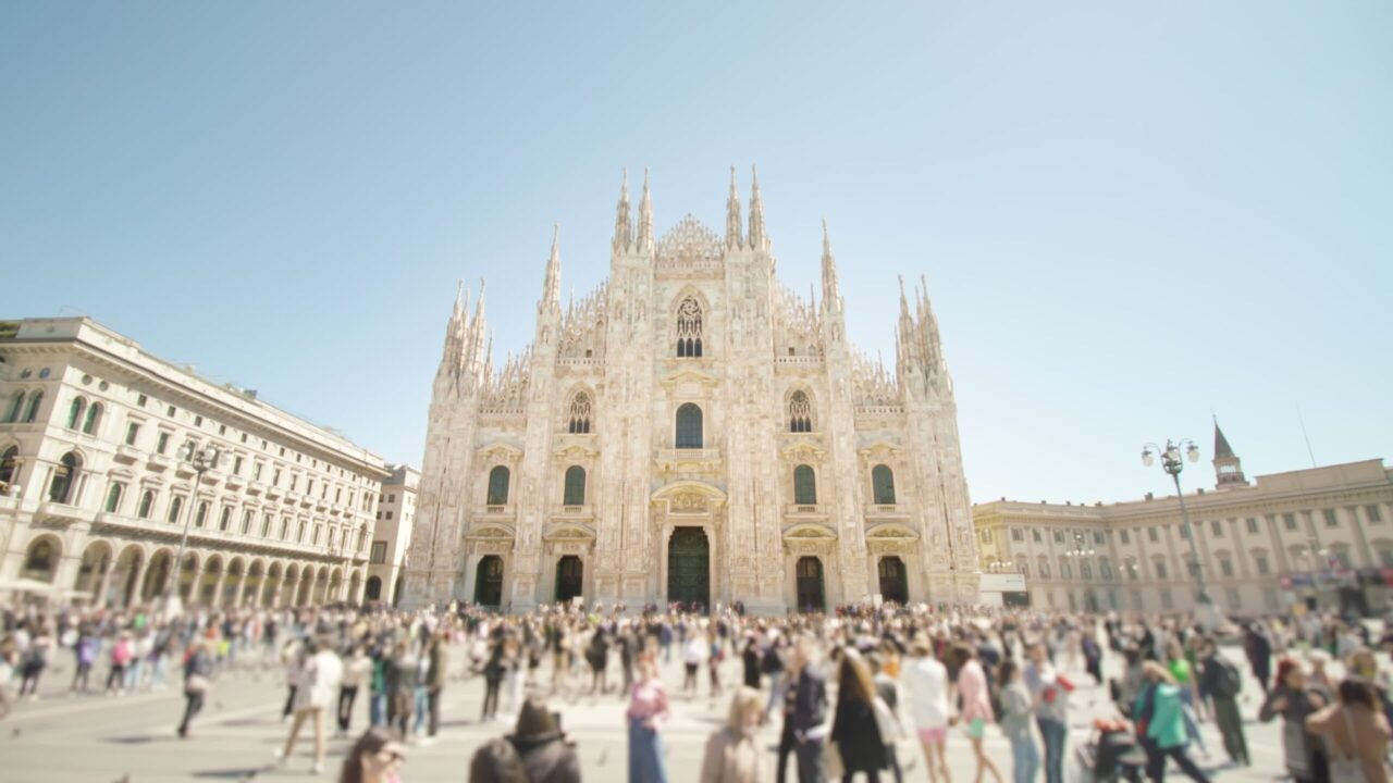 People walk on square against Duomo in center of Milan