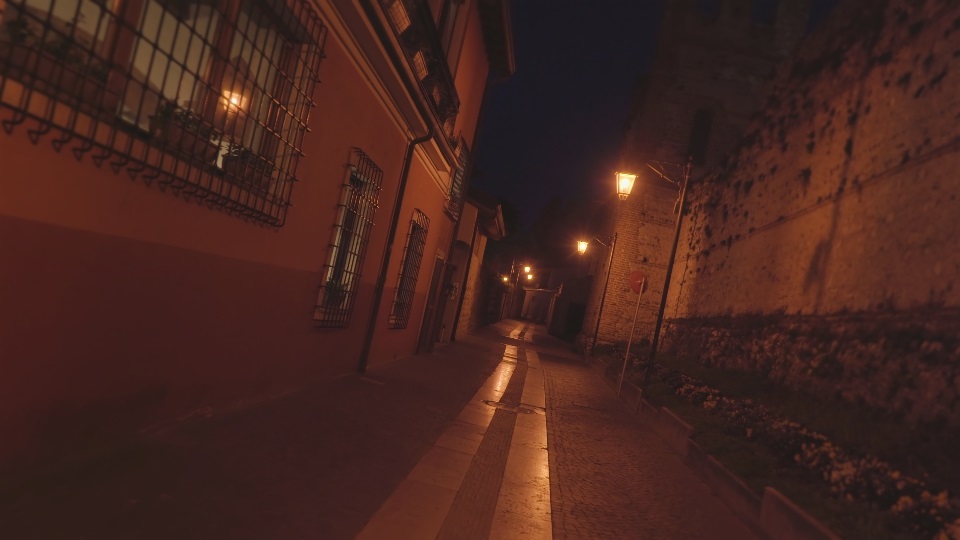 Bright lanterns illuminate narrow street of Italian town