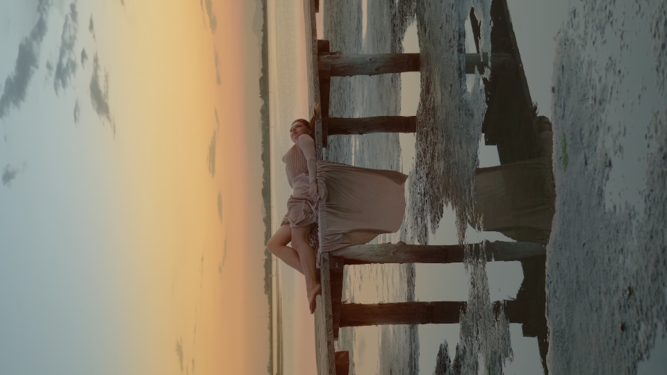 Woman in elegant dress lying on the walk way