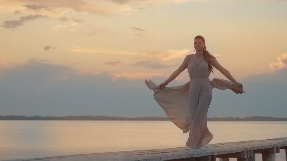 Beautiful model walks elegant on the beach walkway