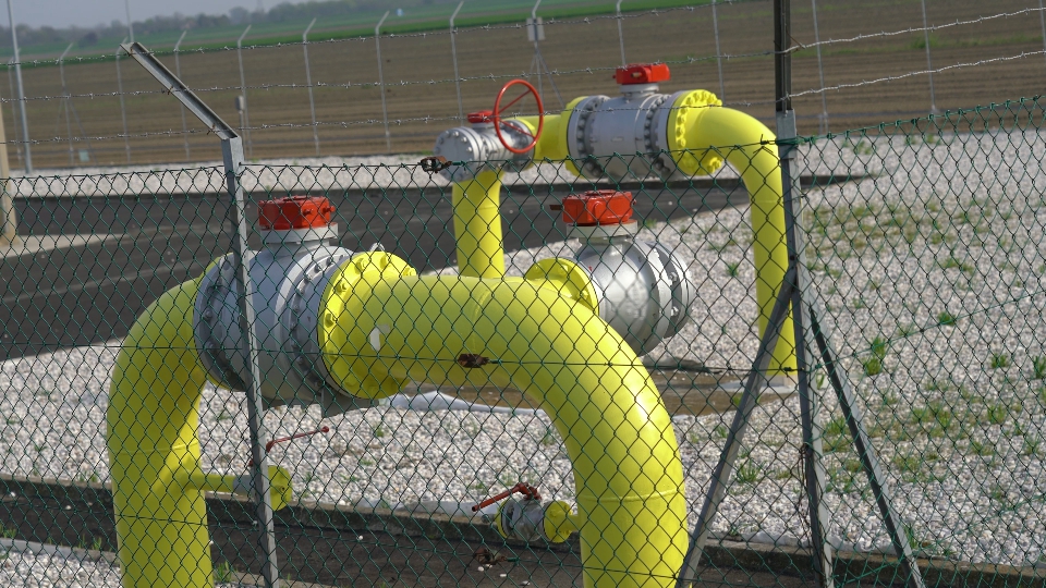 Closed yellow gas pipes in the fence