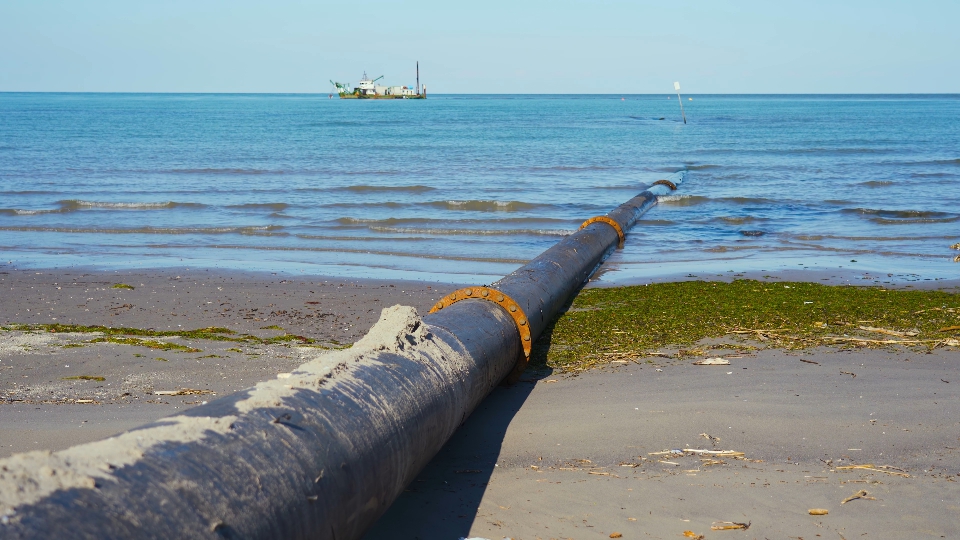 Hose for carrying sand on the beach from the sea floor