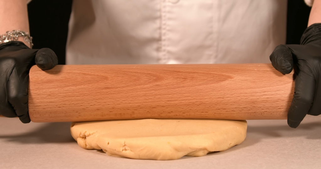 Dough is crushed with rolling pin