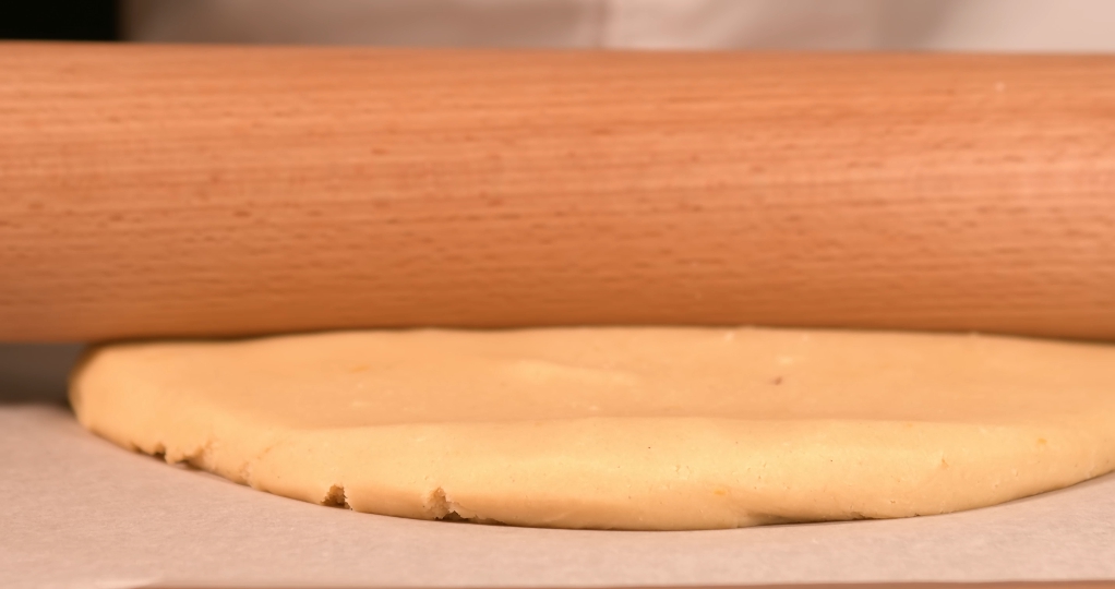 Dough is crushed with rolling pin