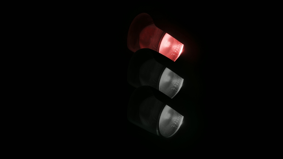 Lamps glow on vintage traffic light on black background