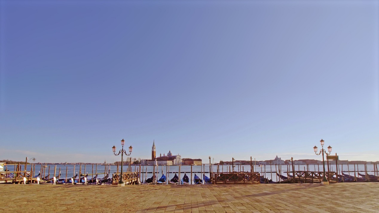 Shore of Venice with parked gondolas