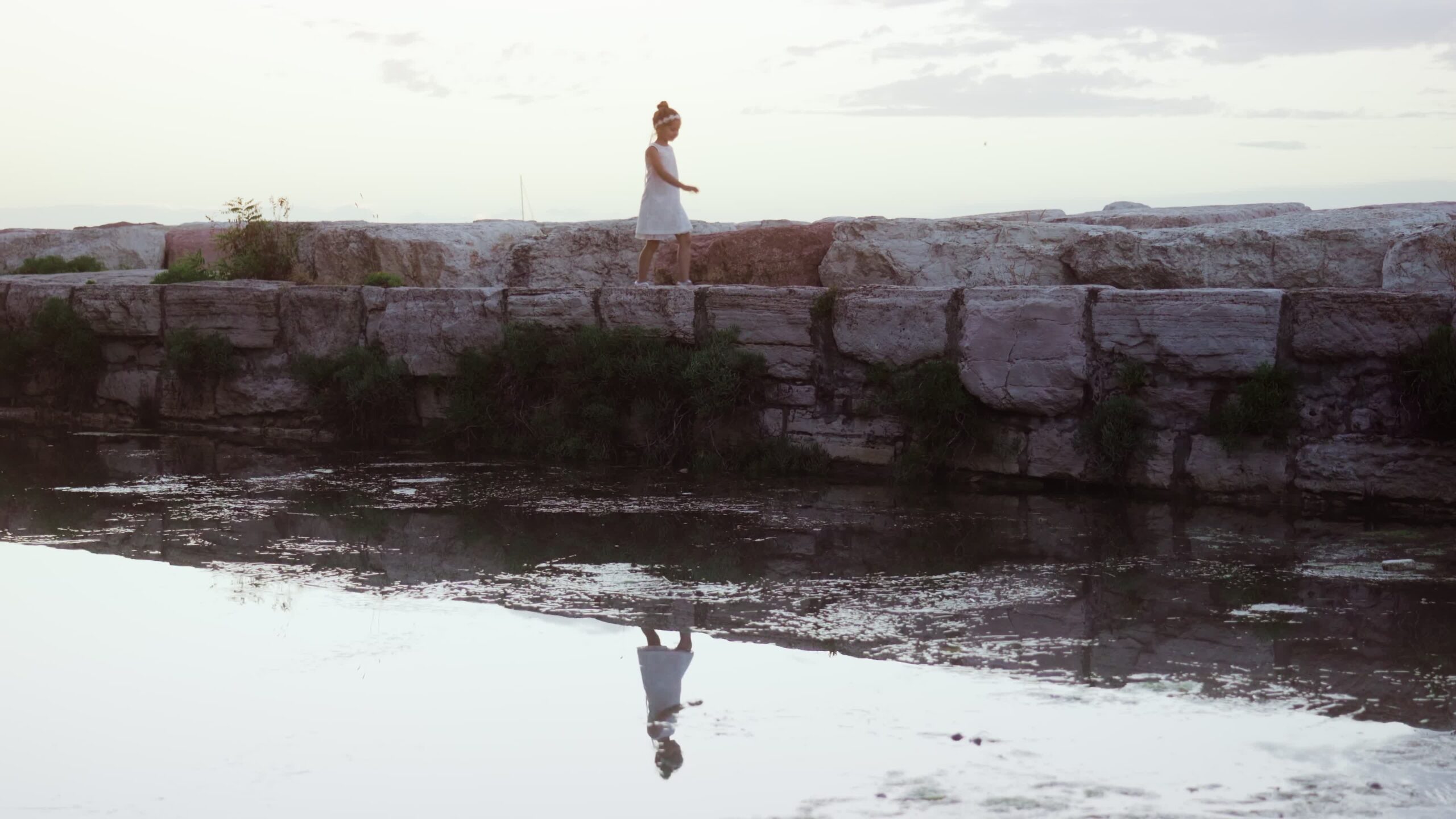 Little girl walks on the dike