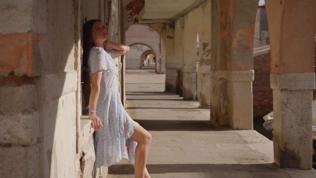 Young Woman in Venice: Sitting on the Wall of a House