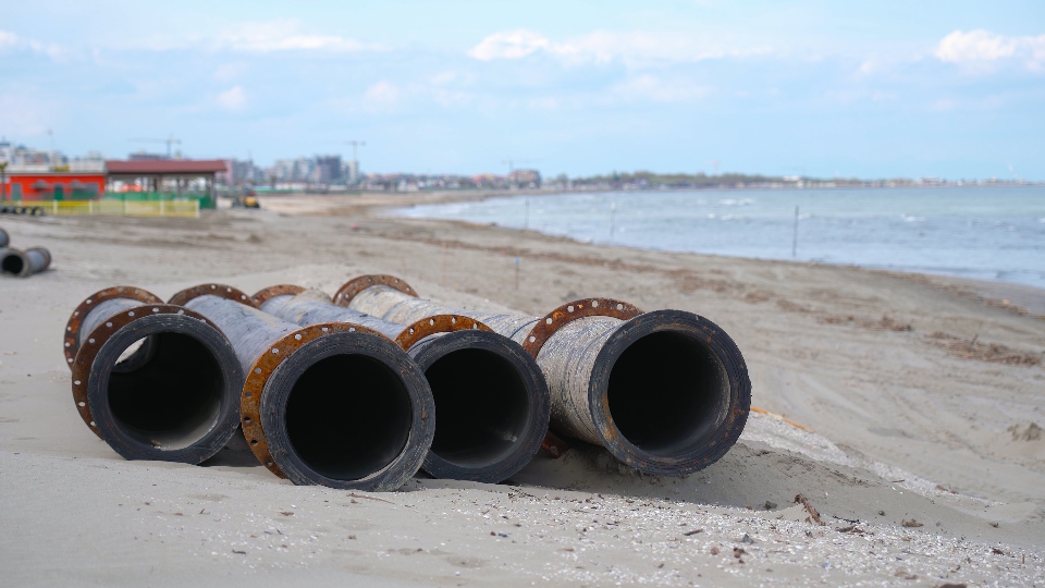 Four tubes resting on the sand of the beach