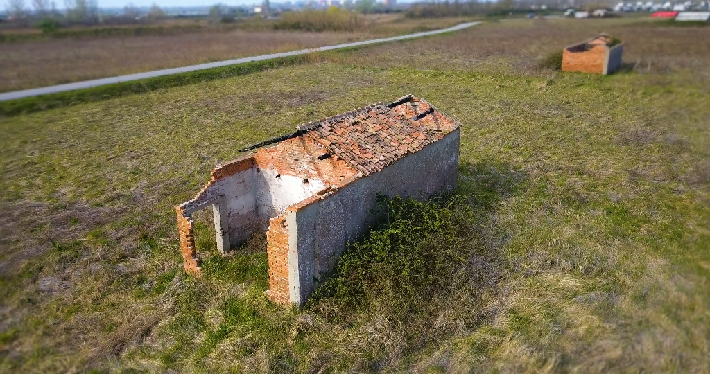 House built of bricks in the middle of the green field