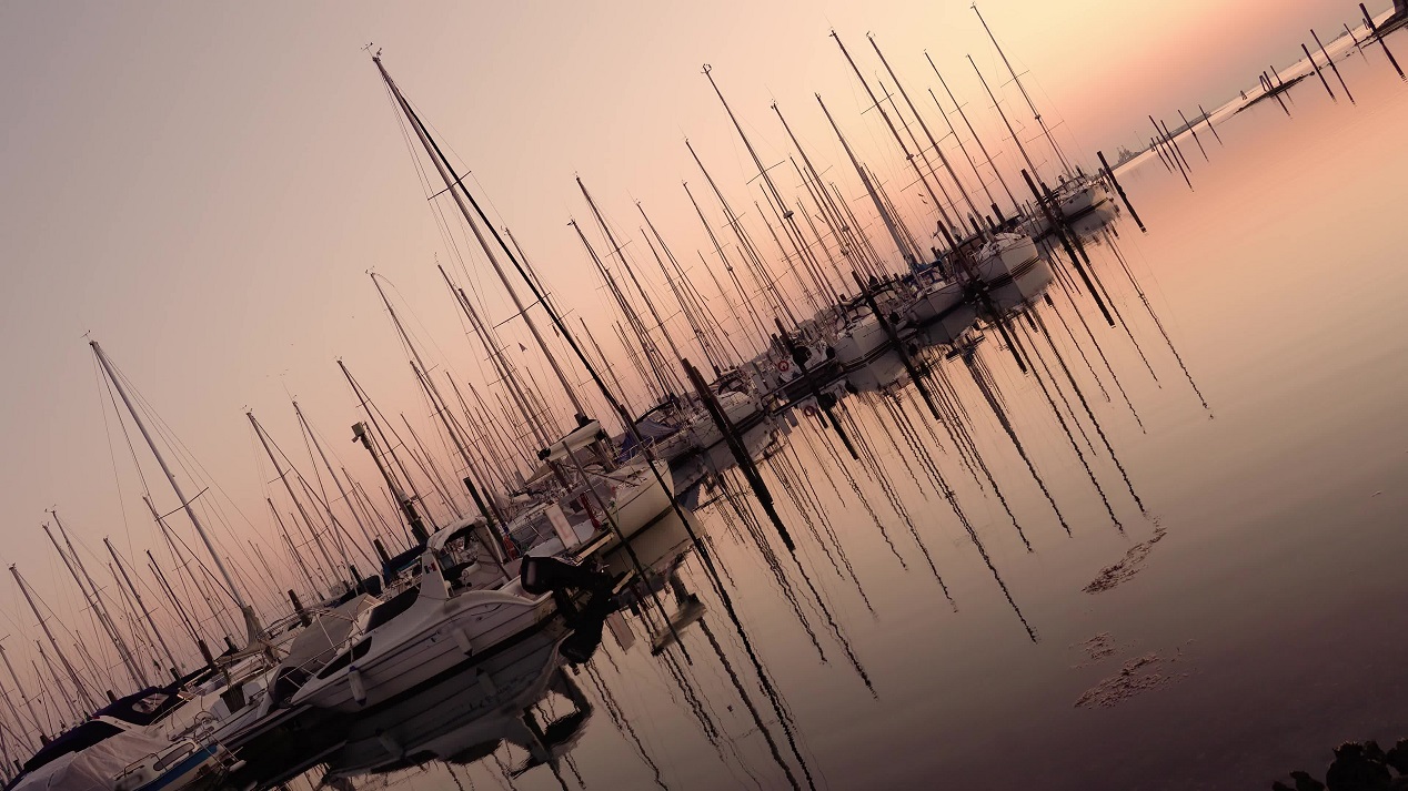 Sailboats parked with reflections in the water