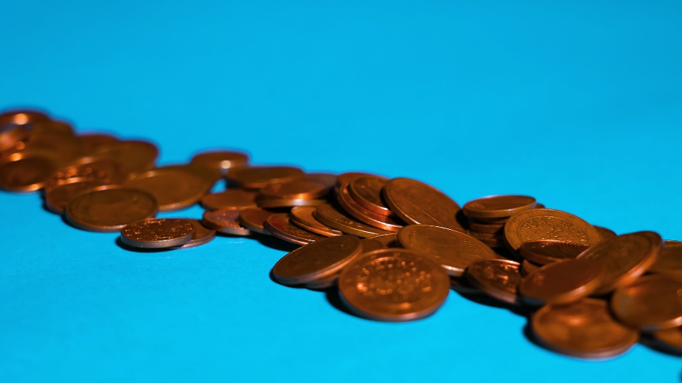 One euro cent coins on a blue background