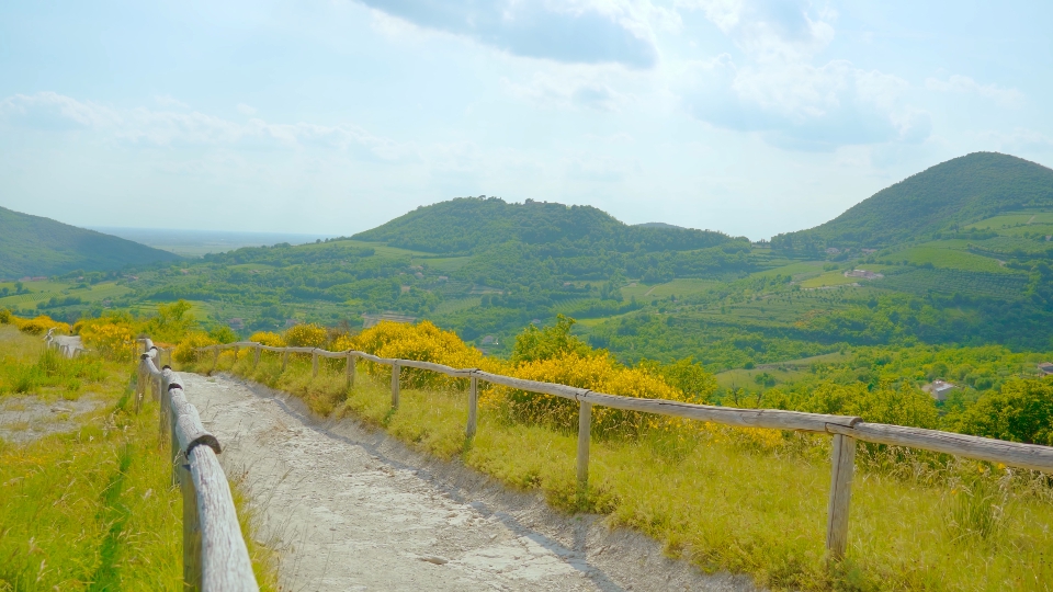 Footpath between green nature and hills