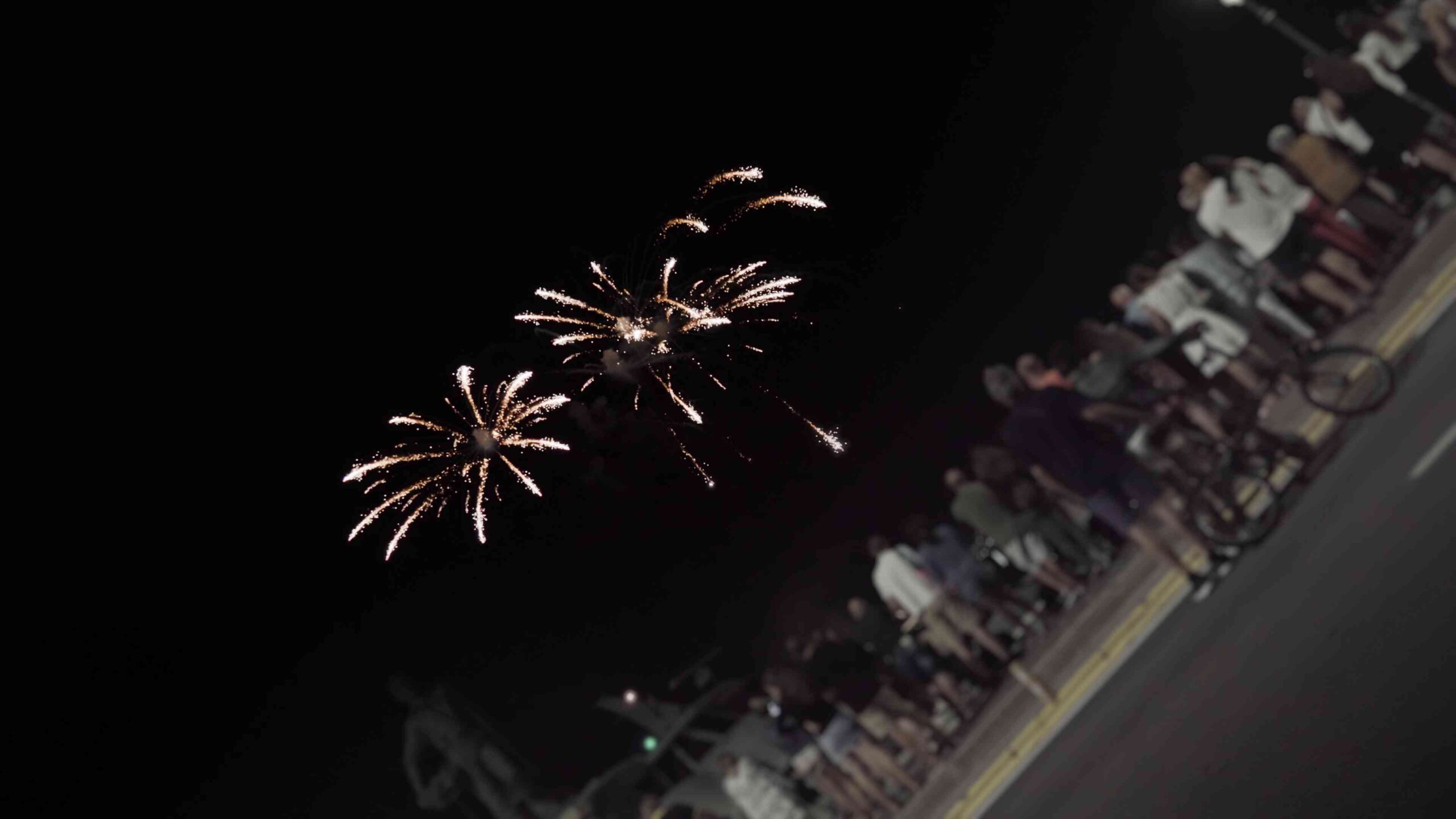 Fireworks in front of the street with people