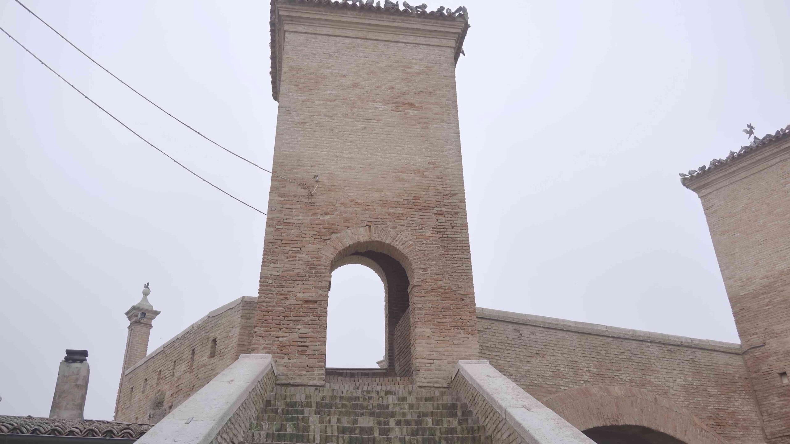 Climb the ancient stairs under a tower