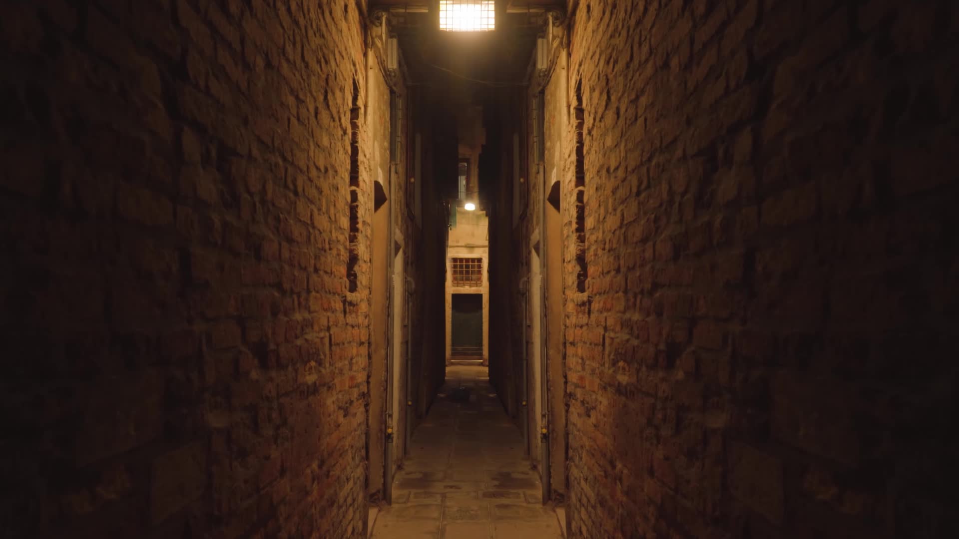 Night narrow street between brick walls