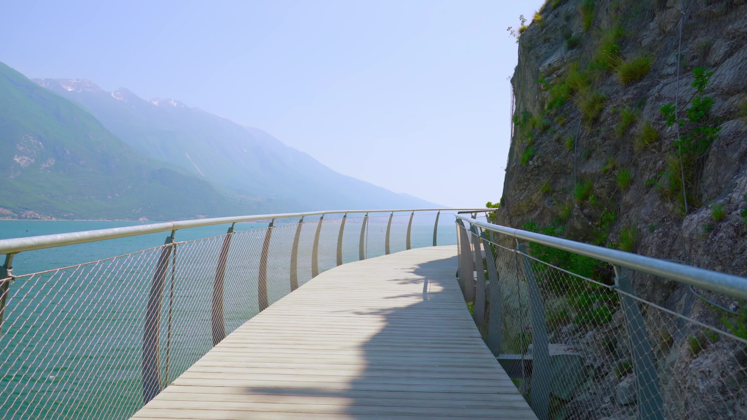 Pedestrian path suspended over the lake between the mountains