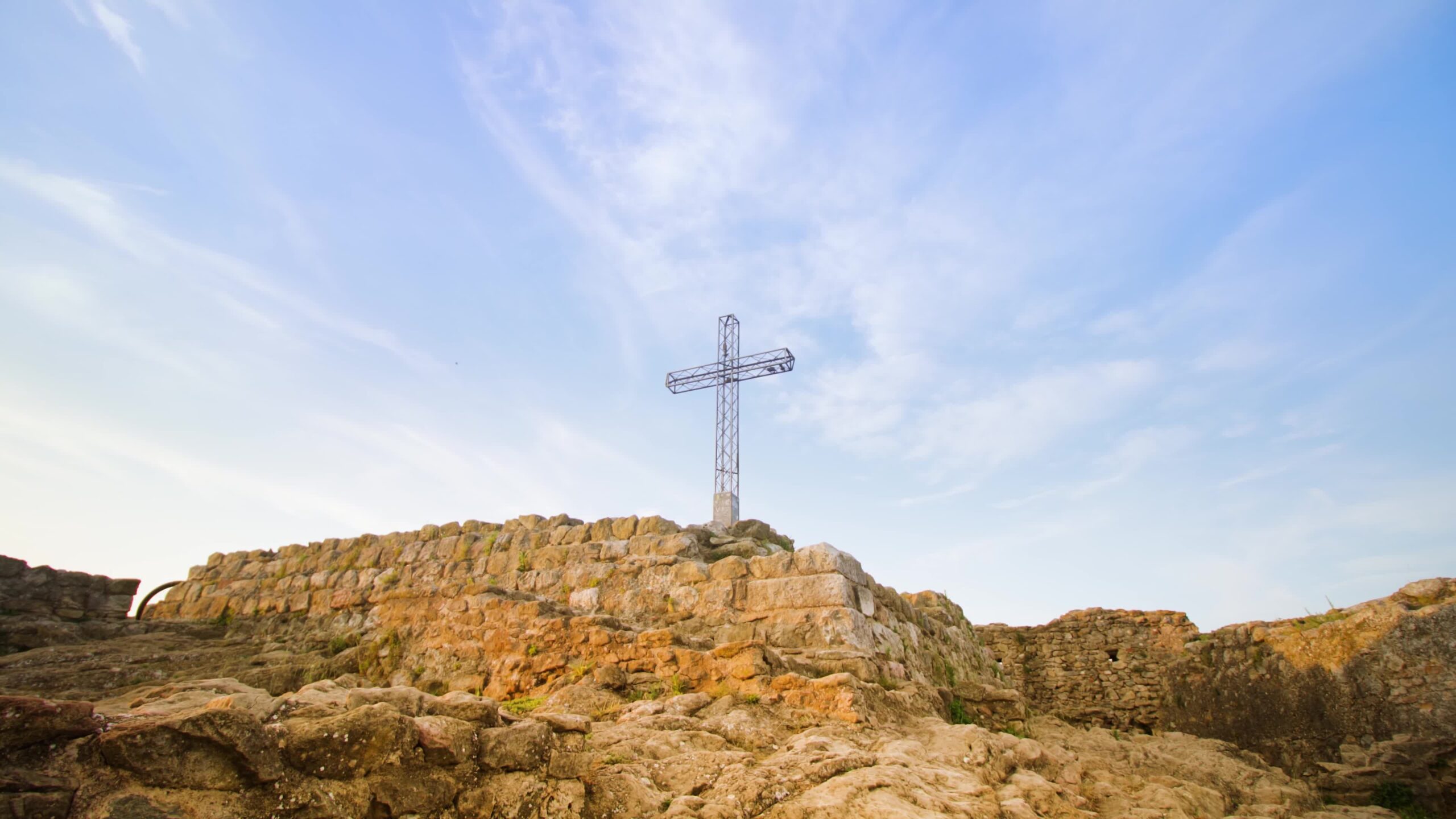 Metal cross among ancient ruins