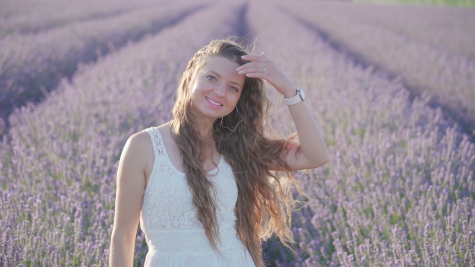 Woman smiles touching her hair