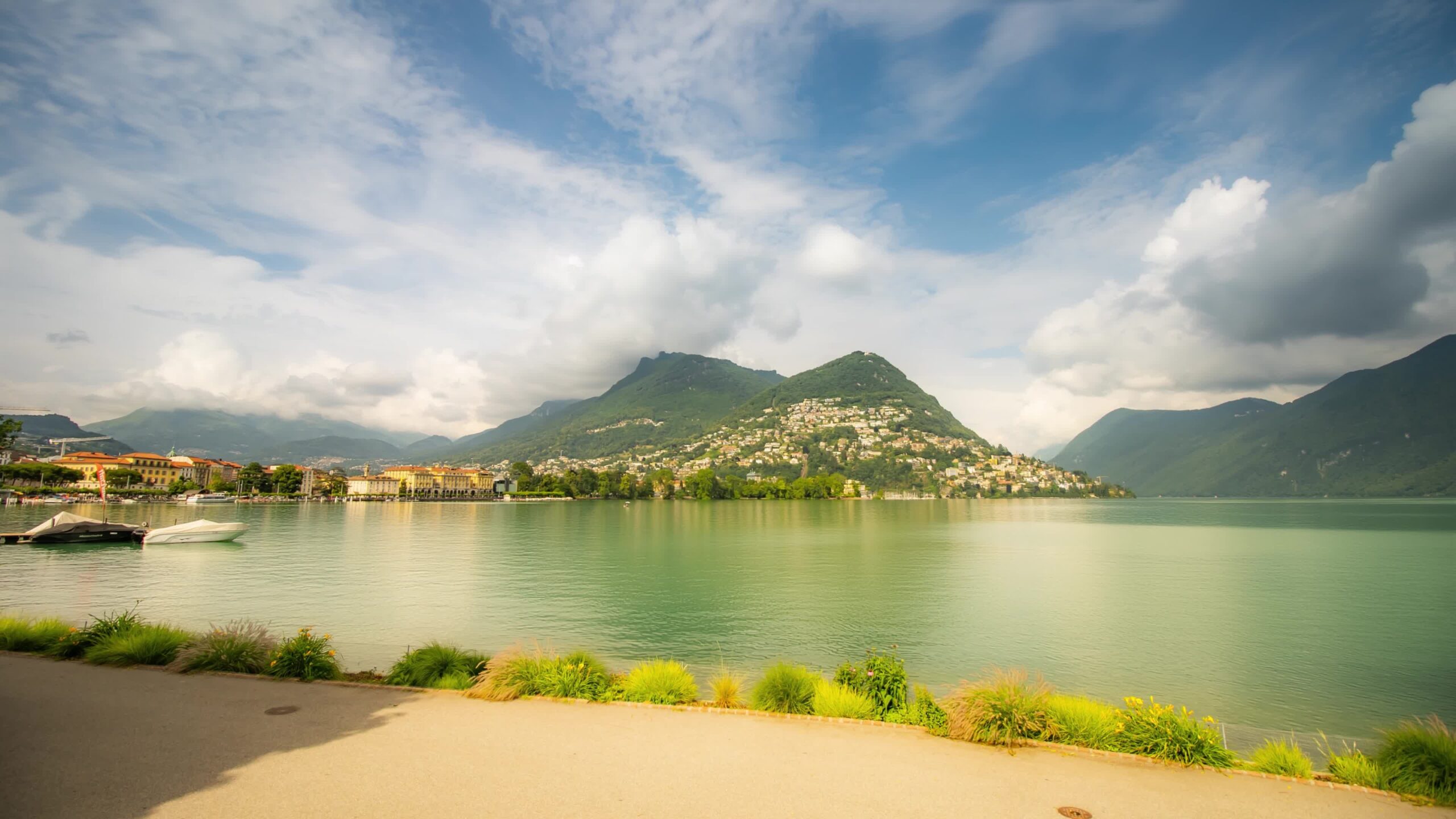 Lugano riverside and green mountains