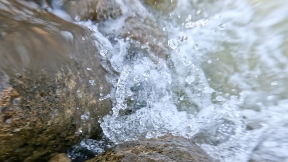 Splashing water on the rocks in slow motion