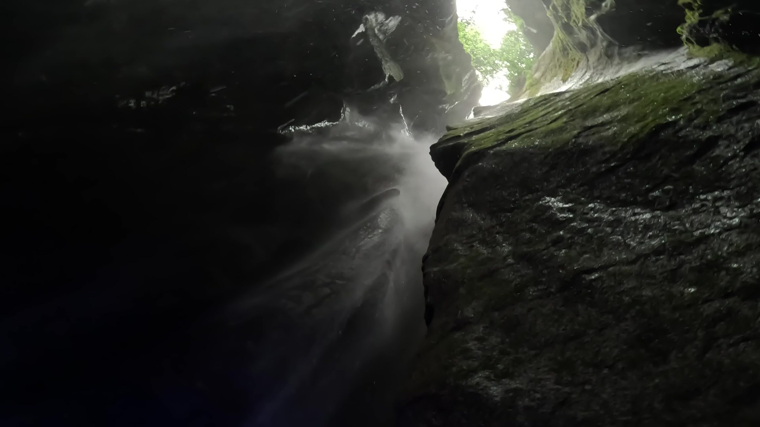 Cascade water splashes between mountain rocks