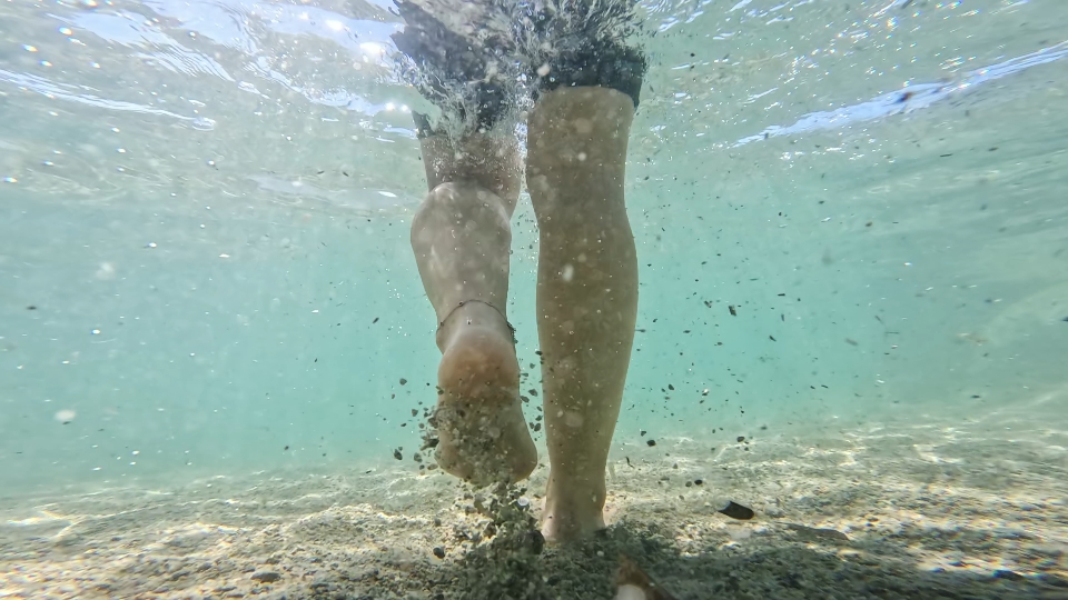 Legs of woman walking in water