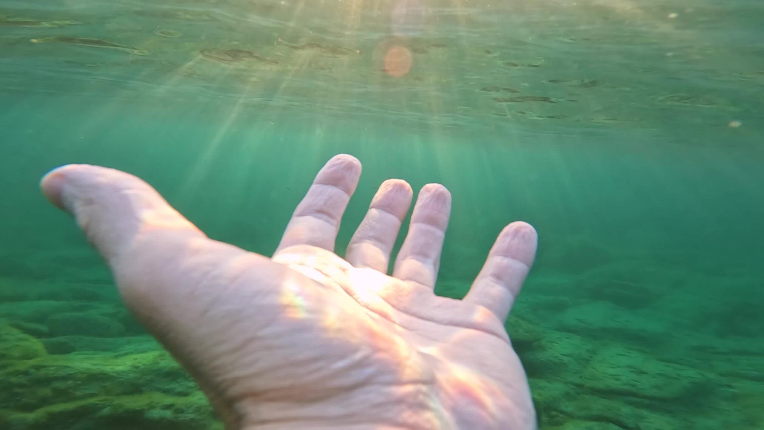 Sunbeams from the sea illuminate the hand