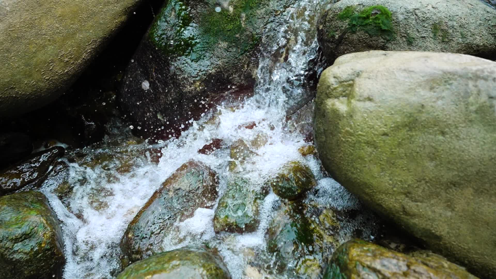 Water hits rocks in slow motion