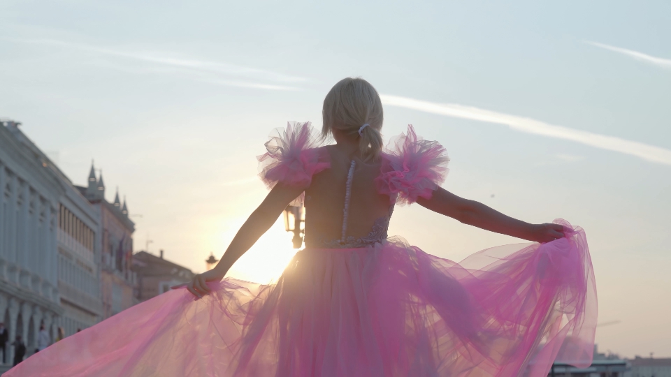 Woman in pink dress posing in Venice