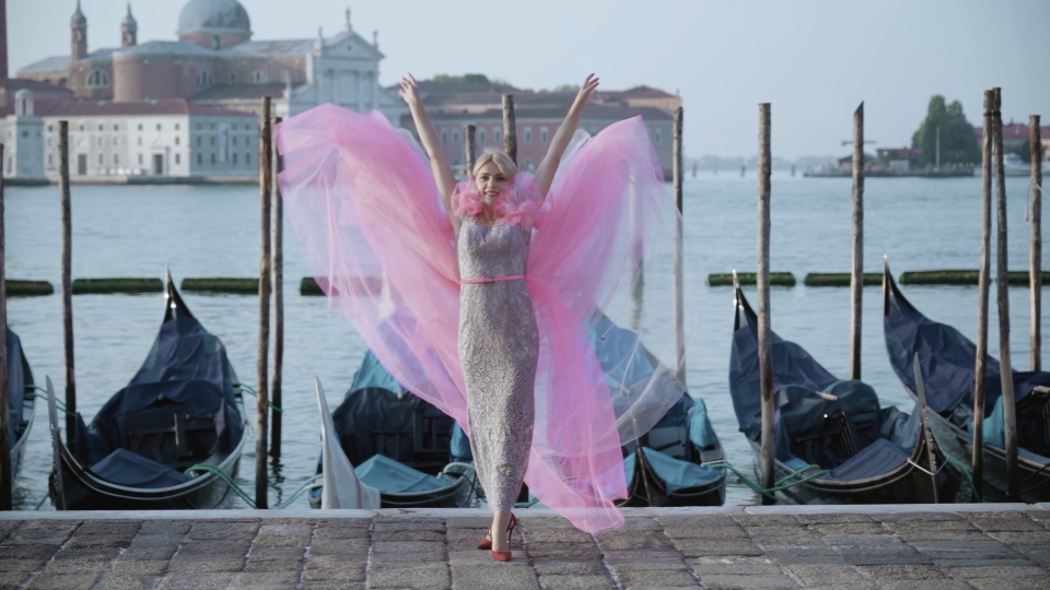 Happy woman in pink dress in Venice