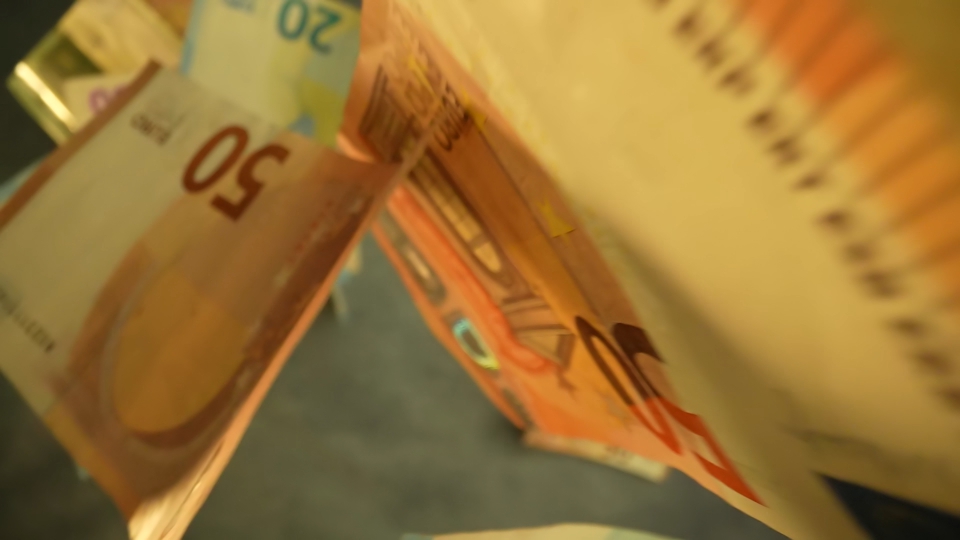 Banknotes fall in slow motion