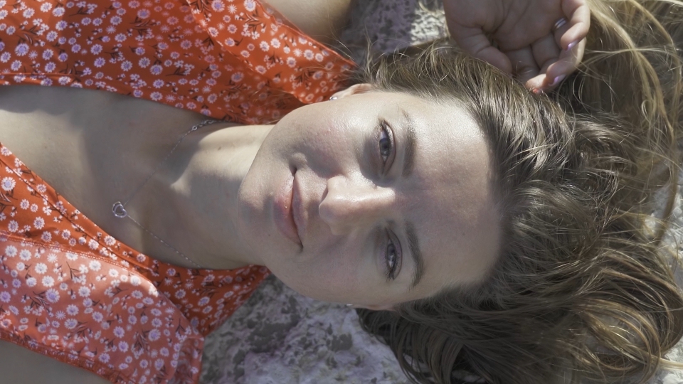 Woman lying on stones in the foreground