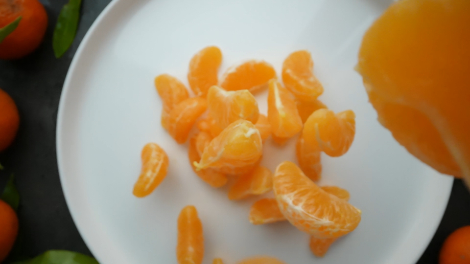 Delicious Clementines Landing on a Plate