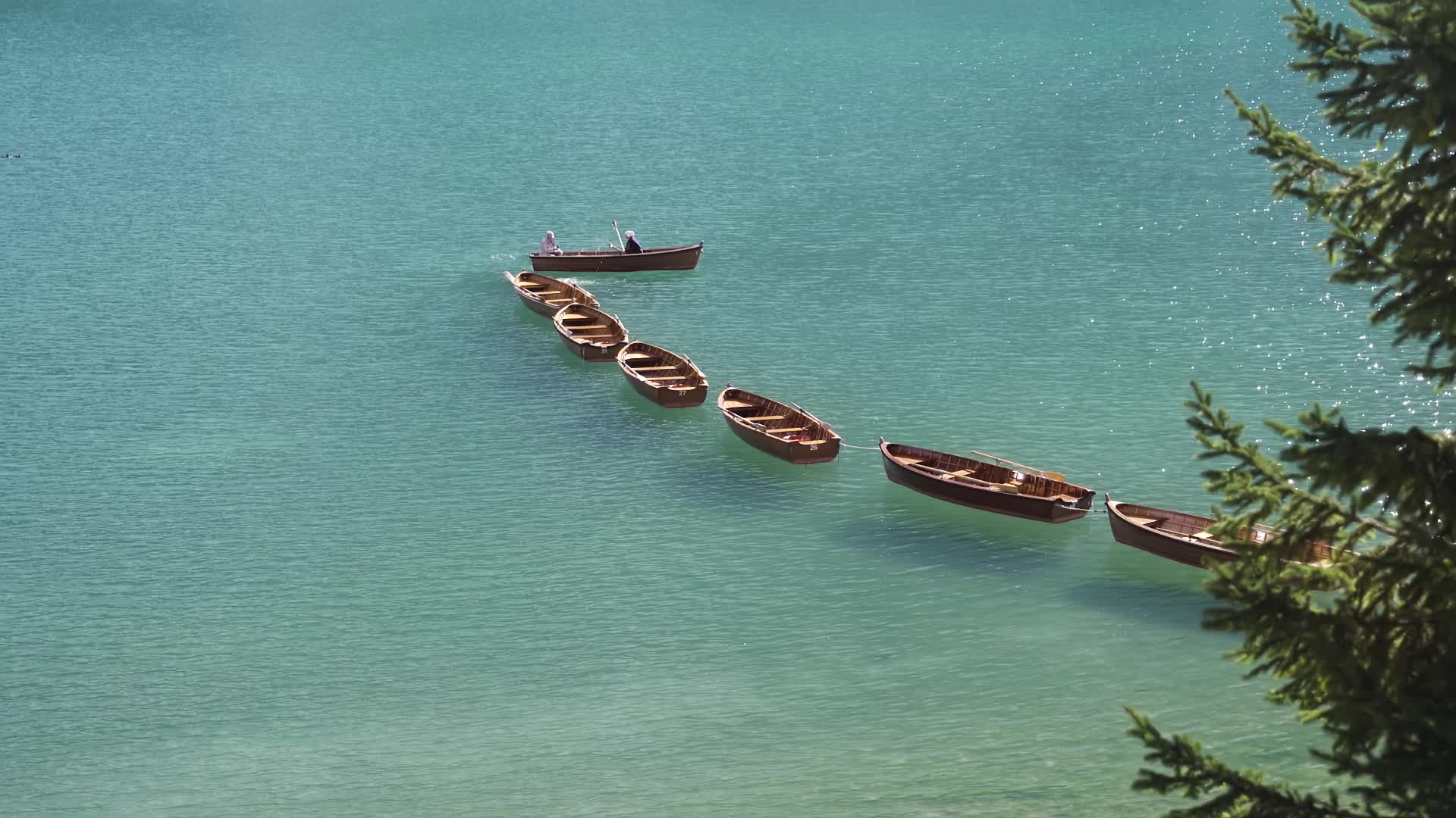 Wooden boats moored on the blue lake