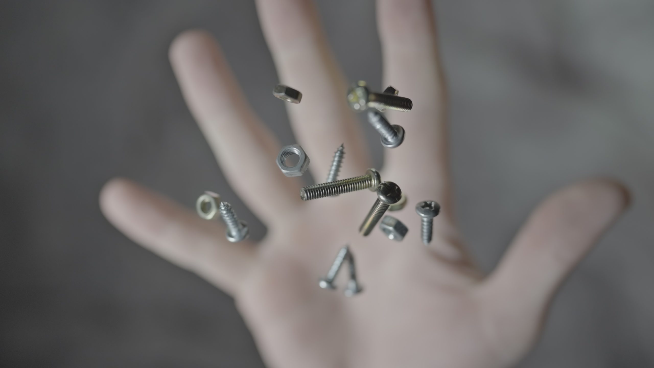 Screws and bolts thrown up with the hand