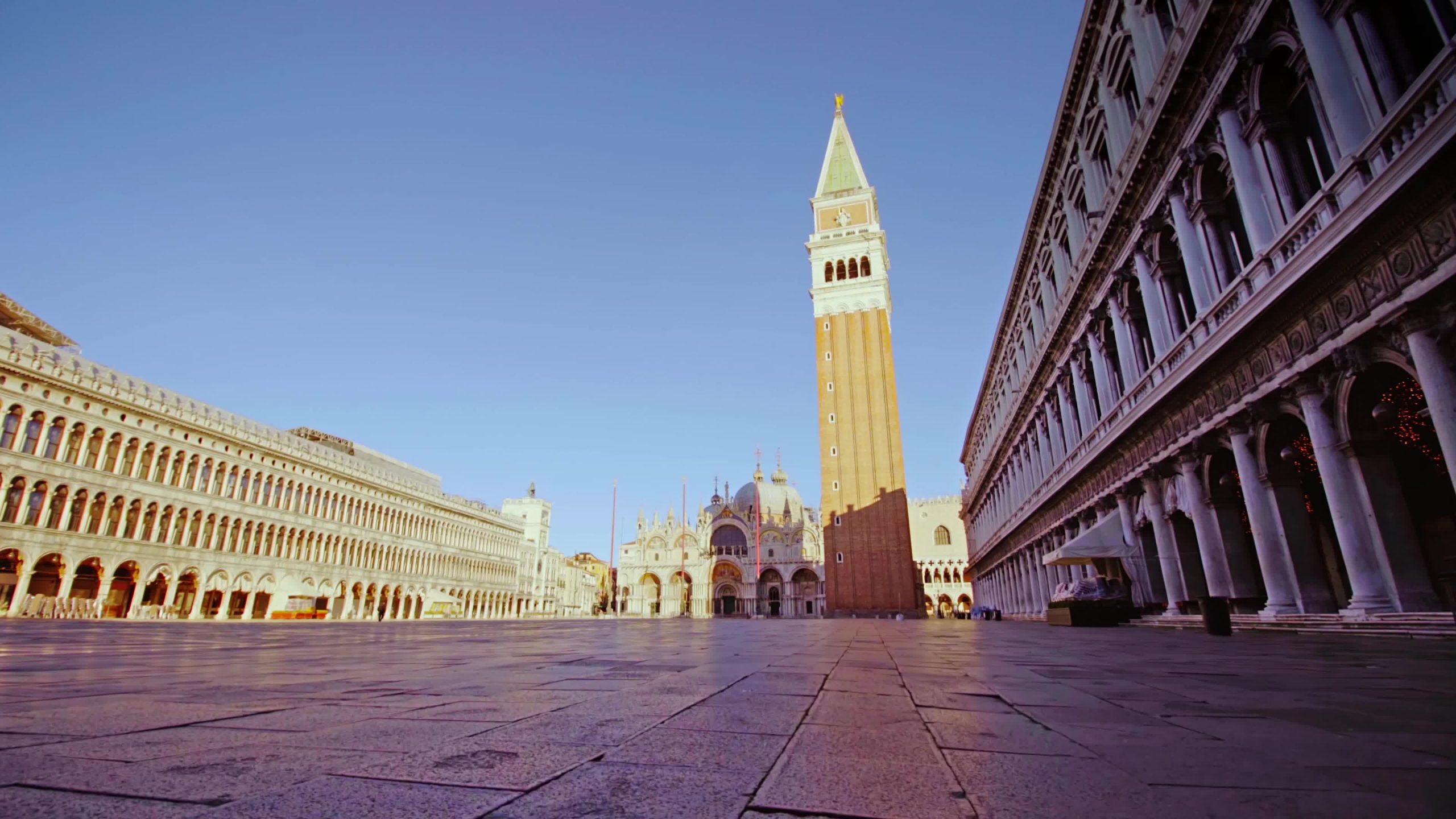 Movement along the deserted Piazza San Marco at sunset during the lockdown