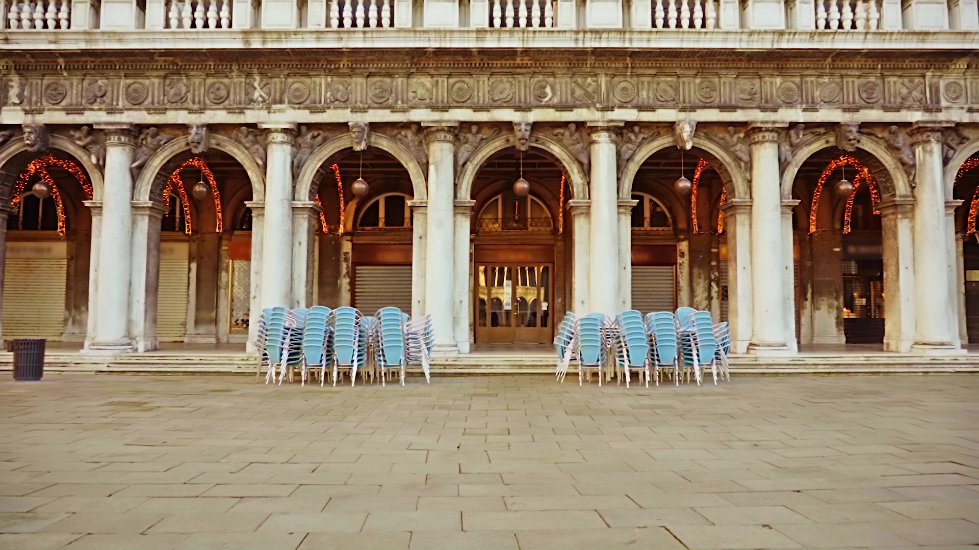 Chairs and tables near a closed restaurant on St. Mark’s Square